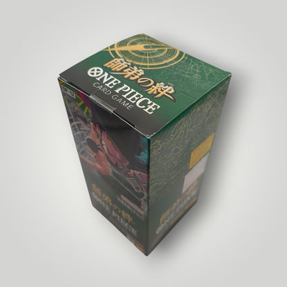 Green OP-12 Legacy of the Master Japanese One Piece Card Game sealed booster box with gold text.