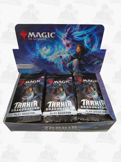 The Gathering Tarkir Dragonstorm Play Booster Packs in open display box with fantasy artwork.